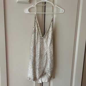 NBD cream, and  metallic silver dress